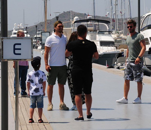 cagatay ulusoy and kivanc tatlitug are talking in bodrum yacht marina